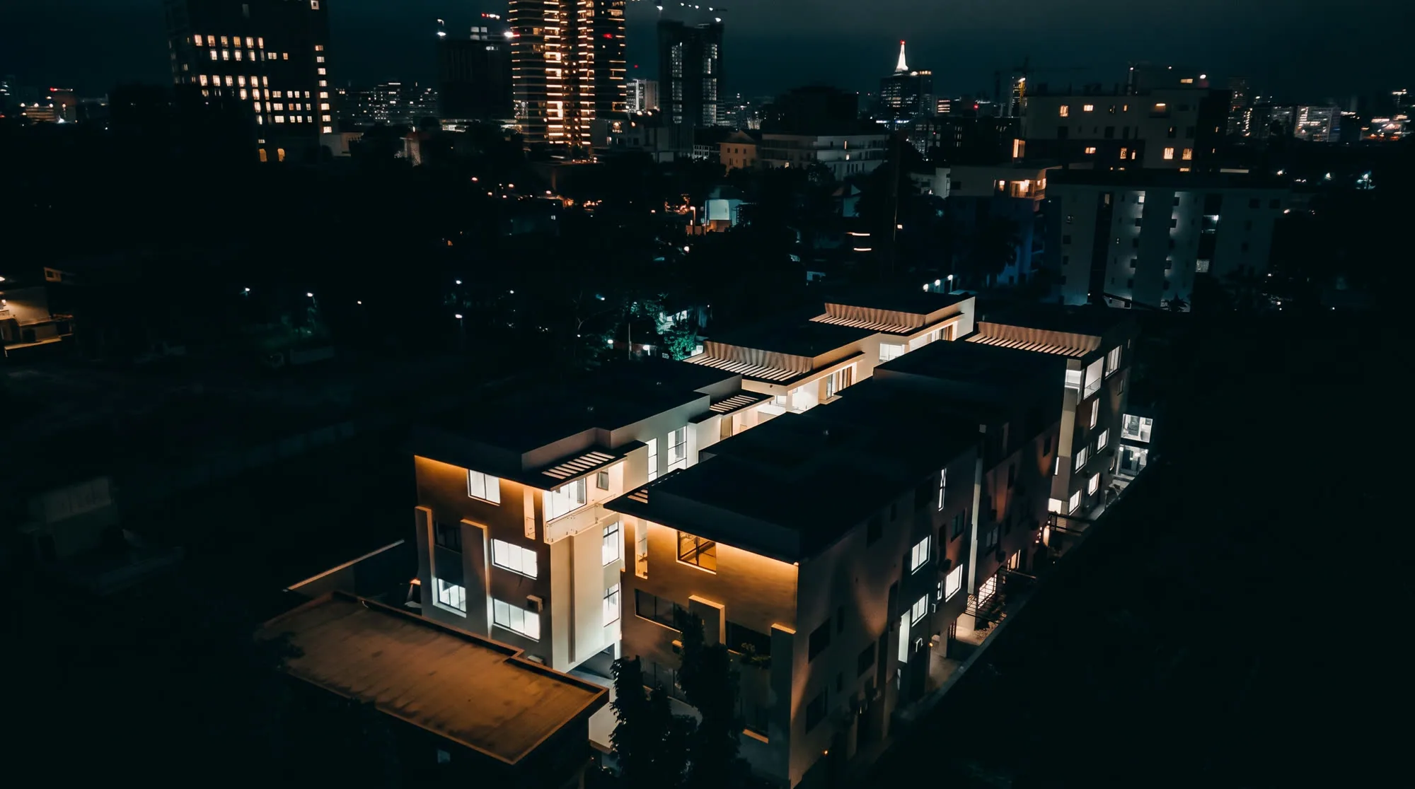 Jasmine Villa lit at night above the Ikoyi skyline, Lagos